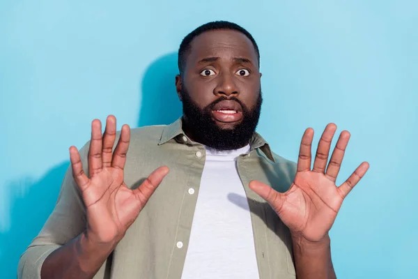 Photo of young african man show arms no refuse decline symbol scared isolated over blue color background — Stock fotografie