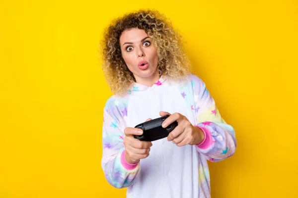 Portrait of attractive amazed addicted wavy-haired girl in pajama playing video game pout lips isolated over bright yellow color background — Fotografia de Stock