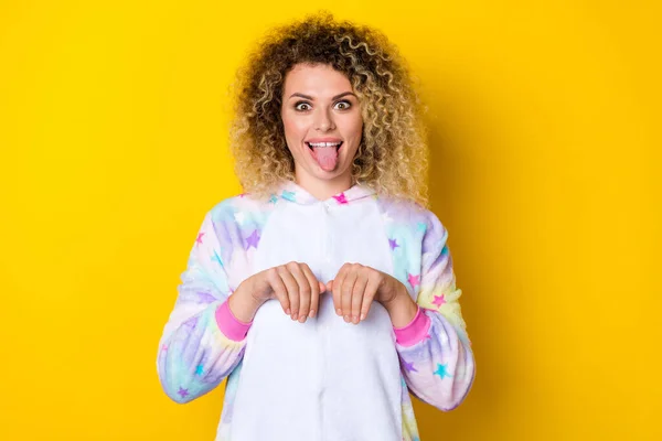 Portrait of attractive cheerful foolish childish wavy-haired girl in pajama pretending like dog isolated over vivid yellow color background — Fotografia de Stock