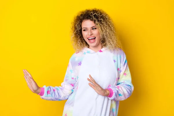 Portrait of attractive cheerful carefree wavy-haired girl in pajama dancing having fun isolated over bright yellow color background — Stock Photo, Image