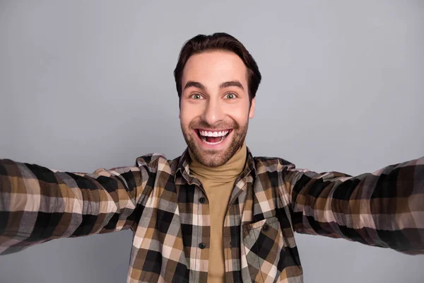 Photo of sweet excited guy dressed checkered shirt tacking selfie smiling isolated grey color background — Stockfoto