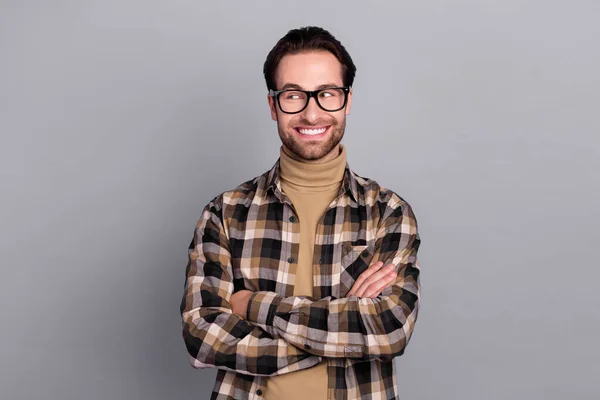 Photo of dreamy clever guy dressed checkered shirt glasses arms folded empty space isolated grey color background — Zdjęcie stockowe