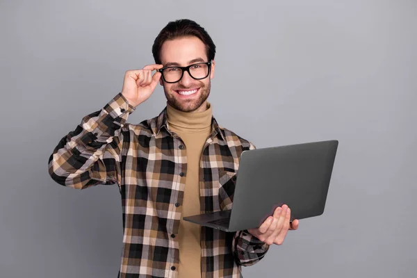 Photo of confident cute guy dressed checkered shirt arm glasses chatting modern device isolated grey color background — Stockfoto