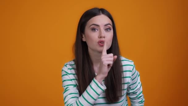 Cute lady finger mouth ask not tell rumor isolated mustard color background — Wideo stockowe