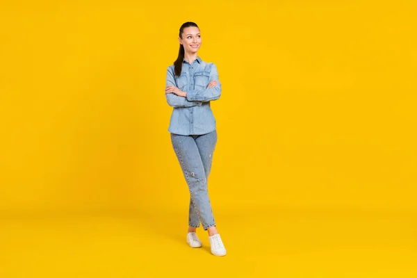 Full length body size view of attractive cheerful girl posing folded arms thinking copy space isolated over bright yellow color background — 스톡 사진