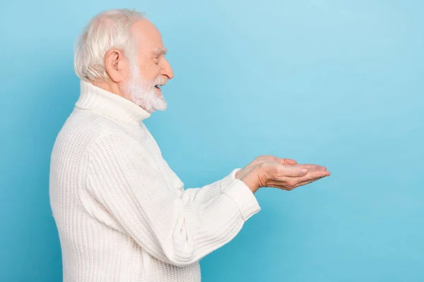 Profile photo of optimistic old man give promo wear white jumper isolated on blue color background