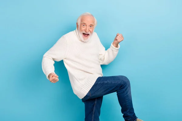 Photo of cool aged grey hairdo man hands fist wear white pullover jeans isolated on blue color background — Photo