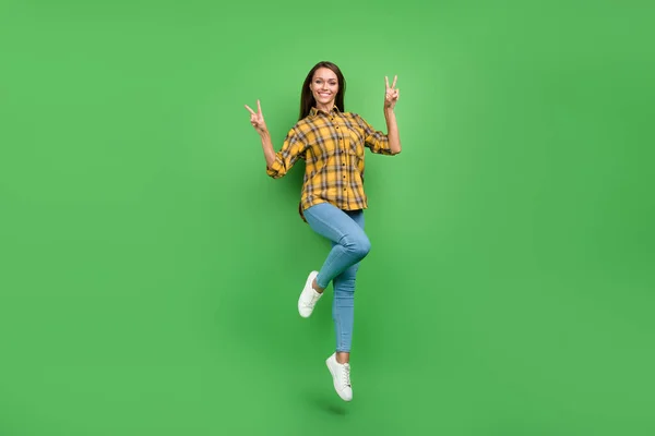 Full size portrait of carefree satisfied person fingers showing v-sign isolated on green color background — стоковое фото