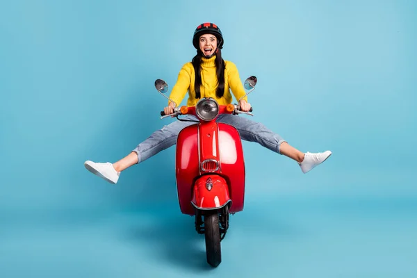 Photo portrait of female scooter rider driving motorcycle crazy playful overjoyed isolated vivid blue color background.