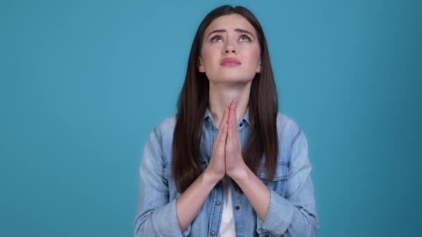Nervous upset lady look up pray isolated blue color background — Stockvideo