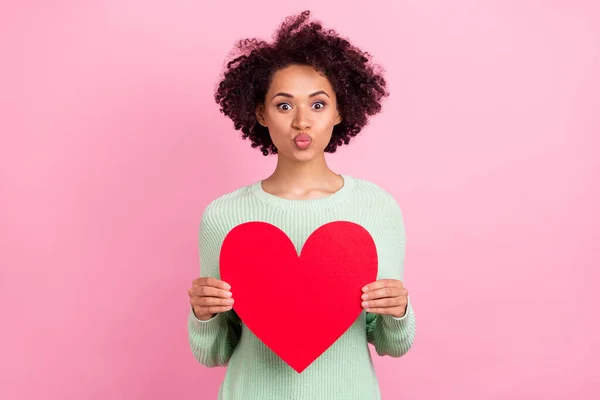 Photo of adorable dark skin lady kiss lips hold heart symbol postcard isolated on pink color background — Zdjęcie stockowe