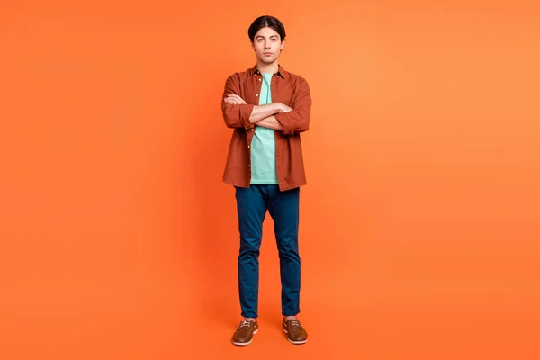 Full size photo of young cool confident businessman with folded hands boss ceo isolated on orange color background — Zdjęcie stockowe