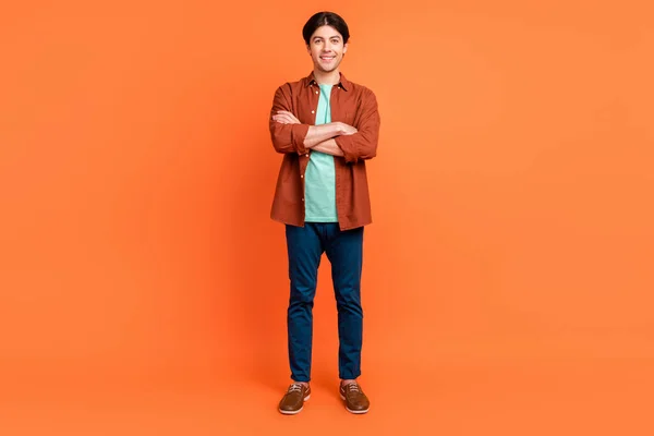 Full size photo of smiling handsome businessman with crossed arms agent boss isolated on orange color background — Zdjęcie stockowe