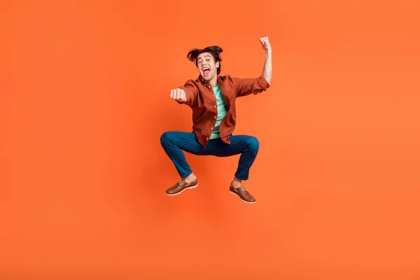 Full size photo of cheerful funky carefree male jumping rodeo cowboy ranch isolated on bright orange color background — Stockfoto