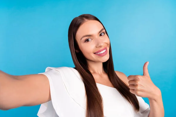 Photo of reliable blogger lady raise thumb up approve choice make selfie wear white blouse isolated blue color background — Photo