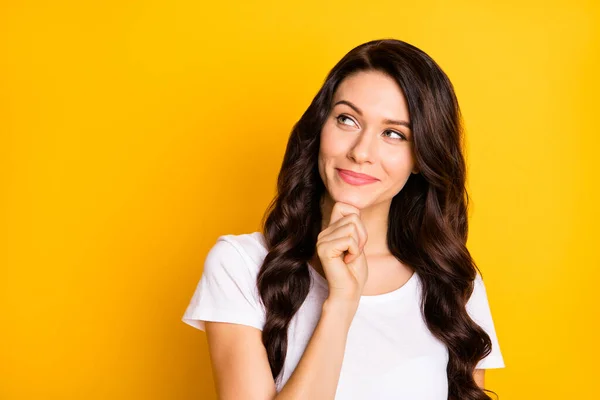 Portrait of attractive cheerful wavy-haired girl creating new solution copy space isolated over bright yellow color background — стоковое фото