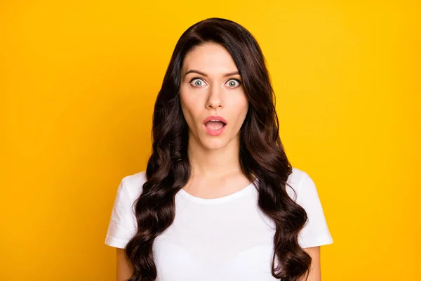 Portrait of attractive amazed wondered wavy-haired girl news reaction isolated over bright yellow color background — Stok fotoğraf