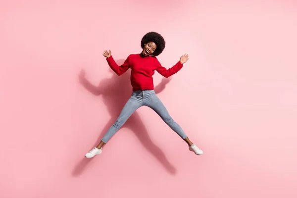 Full length body size view of attractive cheerful girl jumping having fun enjoying good mood isolated over pink pastel color background — Stockfoto