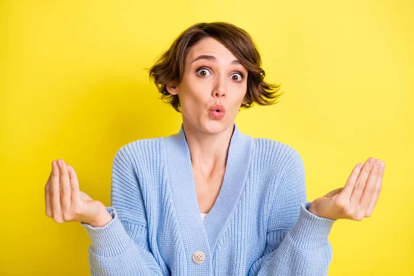 Portrait of lovely amazed brown-haired girl saying news pout lips isolated over bright yellow color background — Stock fotografie