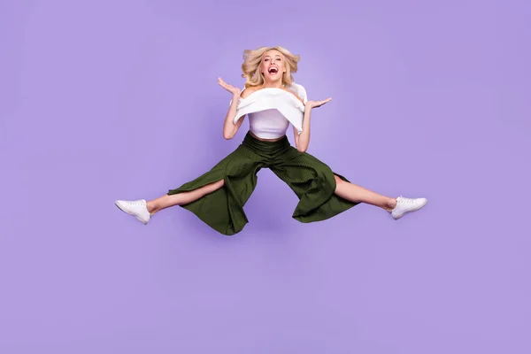 Full length body size photo girl jumping high careless in stylish outfit isolated pastel purple color background — Stok fotoğraf