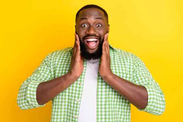 Portrait of astonished cheerful person arms on cheeks open mouth incredible reaction isolated on yellow color background — Stock Photo, Image