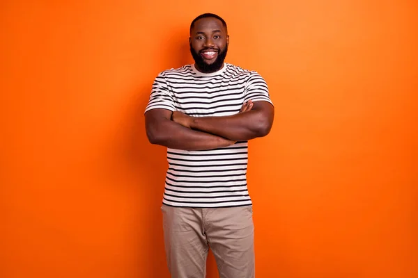 Foto van jonge vrolijke Afrikaanse man gekruiste handen dragen casual kleding geïsoleerd over oranje kleur achtergrond — Stockfoto