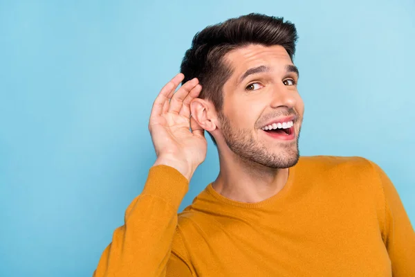 Profile side photo of young cheerful man happy positive smile eavesdrop listen gossip isolated over blue color background — Stock Photo, Image