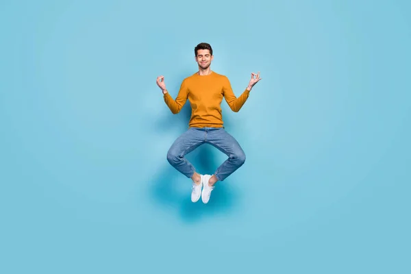 Foto em tamanho completo do jovem feliz sorriso positivo saltar para cima meditar equilíbrio ioga om isolado sobre fundo de cor azul — Fotografia de Stock