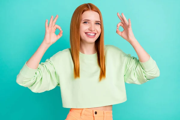 Foto von lustigen entzückende junge Dame gekleidet grüne Kleidung lächelnd zeigt zwei okey Zeichen isoliert Krickente Farbe Hintergrund — Stockfoto