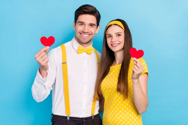 Foto de duas pessoas encantadoras alegres segurar pequeno coração vermelho cartão postal sorriso de dente isolado no fundo de cor azul — Fotografia de Stock
