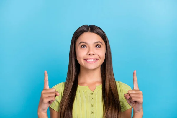Photo of cheerful dreamy little lady direct fingers up empty space sale wear green top isolated blue color background — Stock Photo, Image