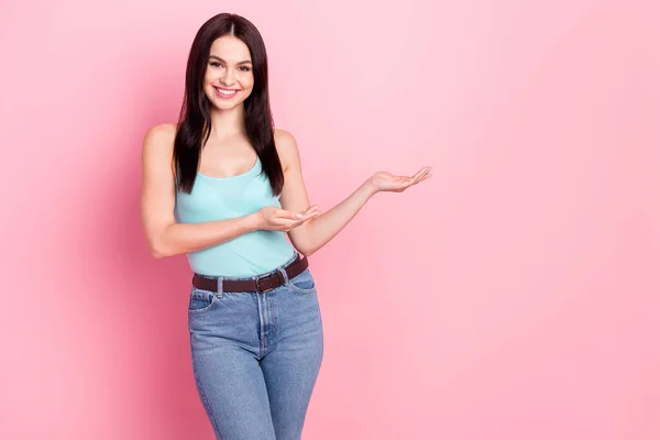 Photo of young cheerful girl happy positive smile show product promo sale suggest isolated over pastel color background — Stock Photo, Image