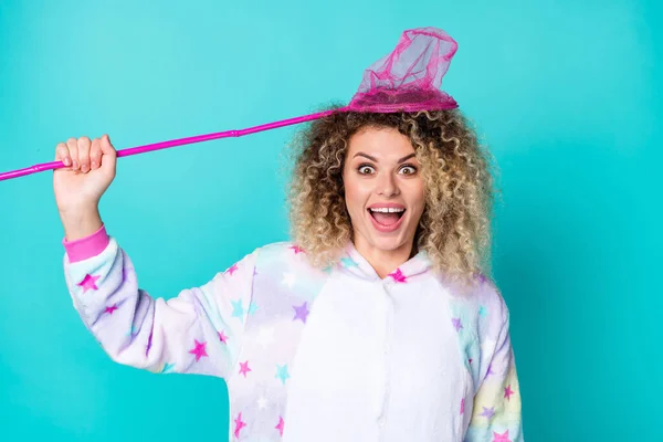 Portrait of attractive cheerful crazy wavy-haired girl holding net catching self isolated over bright teal turquoise color background