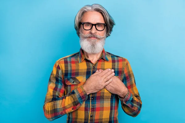 Фото очаровательного пенсионера, одетого в клетчатые очки рубашки руки сердце изолированный синий цвет фона — стоковое фото