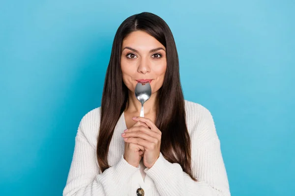 Photo of cool mature lady lick spoon wear white sweater isolated on blue color background — Stock Photo, Image