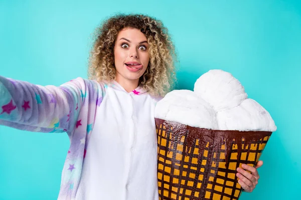 Auto-retrato da moda bela menina de cabelos ondulados louco segurando gelato lambendo lábio isolado no fundo brilhante cor azul-turquesa teal — Fotografia de Stock