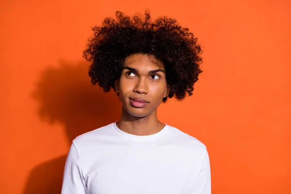 Photo of young guy wonder think dream look empty space imagination isolated over orange color background — Stock fotografie