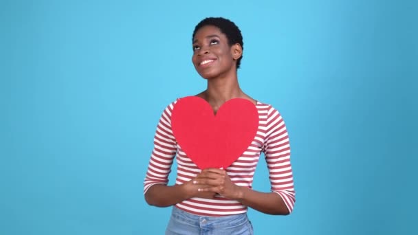 Señora chico abrazo tarjeta corazón sorpresa sentimientos aislado azul color fondo — Vídeos de Stock