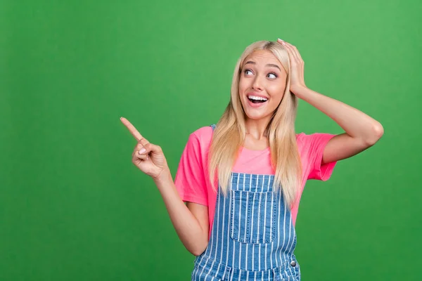 Photo of excited crazy lady direct fingers empty space discount banner wear striped overall isolated green color background — Stock Photo, Image