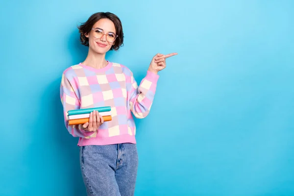 Photo of sweet young brunette lady hold book index promo kopás szemüveg kockás pulóver farmer elszigetelt kék háttér — Stock Fotó