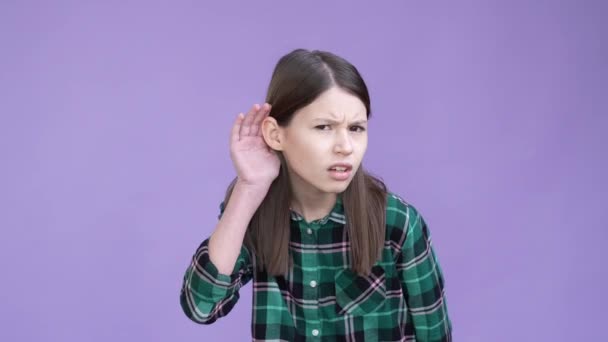 Frustrated kid try listen quiet private news isolated bright color background — Stock Video