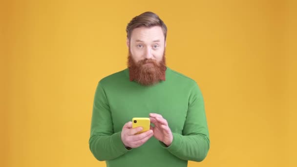 Millennial guy menggunakan gadget komentar repost terisolasi warna latar belakang hidup — Stok Video