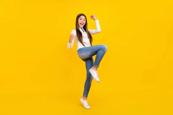 Foto de corpo inteiro de morena legal adolescente menina gritar usar camisola branca jeans sapatos isolados no fundo de cor amarela — Fotografia de Stock