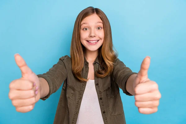 Foto av glada tonåring flicka som ger dig tummen upp hastighet reklam fläkt stöd isolerad på blå färg bakgrund — Stockfoto