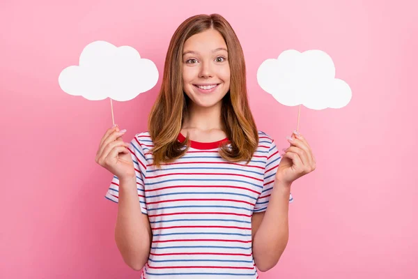 Photo of pretty teenager brown hairdo girl hold clouds wear striped t-shirt isolated on pink color background — Stock Photo, Image