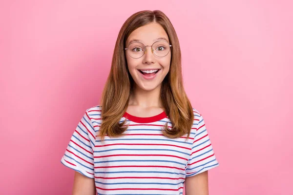 Photo of impressed little brown hairdo girl look camera wear eyewear striped t-shirt isolated on pink color background — Stock Photo, Image