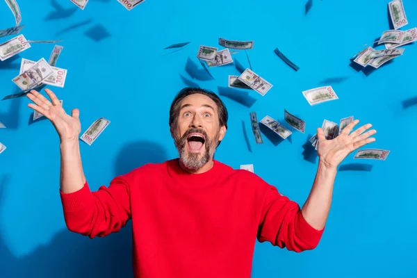 Portrait of attractive cheerful lucky man having fun throwing salary isolated over bright blue color background — Stock Photo, Image