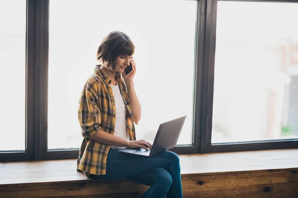 Profile photo of smart millennial bob hairdo lady type laptop talk telephone wear yellow shirt indoors alone — Stock Photo, Image