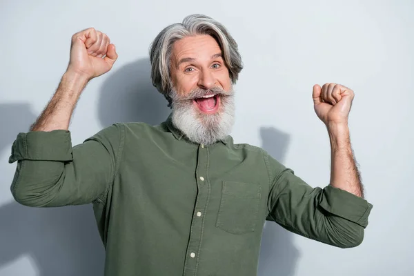 Portrait of attractive cheerful grey-haired man dancing celebrating having fun isolated over gray pastel color background — Stock Photo, Image