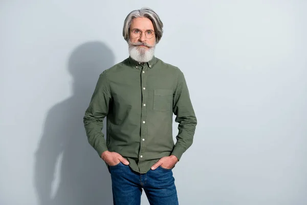 Portrait of attractive content grey-haired man wearing casual formal shirt isolated over gray pastel color background — Stock Photo, Image
